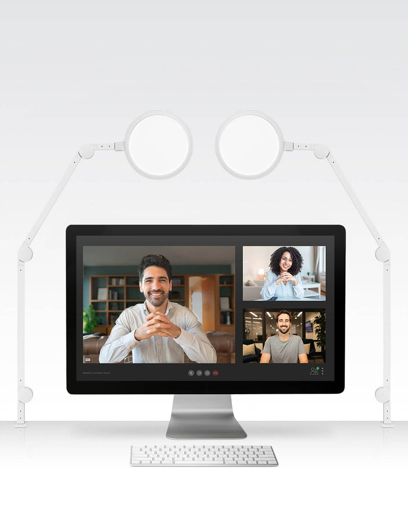 White Lume Cube Edge Light 2 Pack clamped on white desk illuminating computer monitor and workspace.